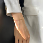 Carina – Pulsera de oro con estructura de platino brillante.