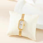 Theresa – Reloj dorado con esfera rectangular.