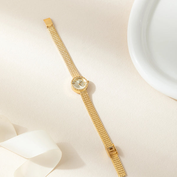 Magdalena – Gold watch with a narrow strap.