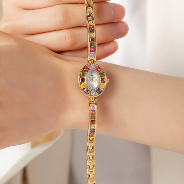Amelie – Reloj dorado con marco de cristal.
