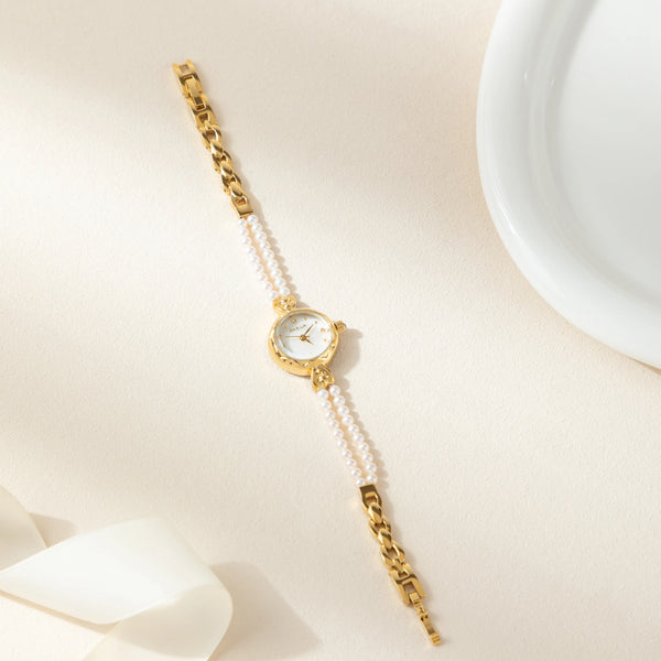 Johanna – Reloj dorado con borde de cristal.