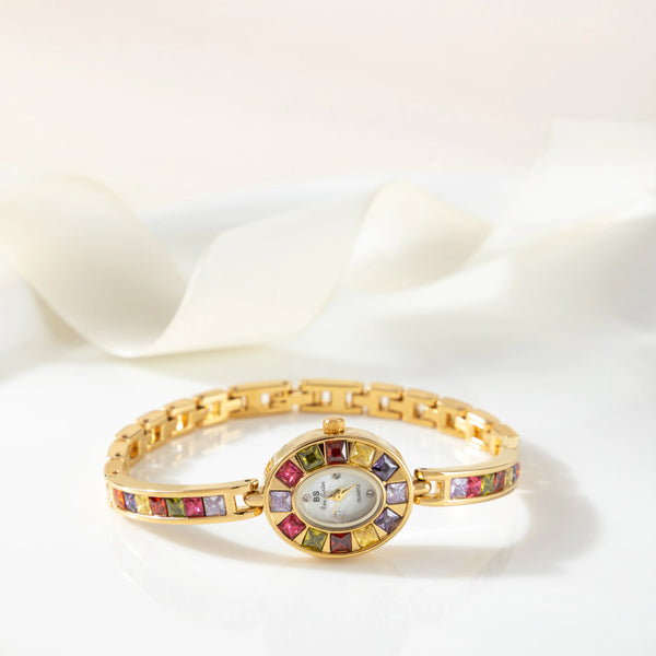Amelie – Reloj dorado con marco de cristal.