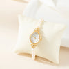 Aurelia – Reloj de dama dorado con esfera en forma de gota.