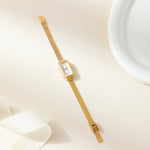 Theresa – Reloj dorado con esfera rectangular.