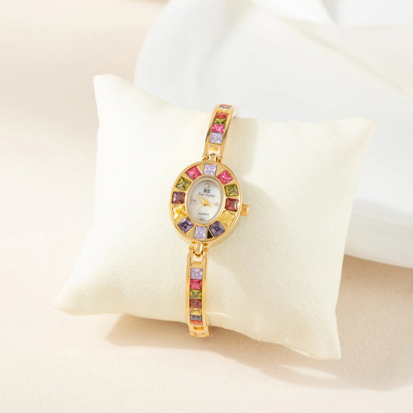 Amelie – Reloj dorado con marco de cristal.