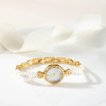 Johanna – Reloj dorado con borde de cristal.