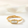 Theresa – Reloj dorado con esfera rectangular.