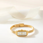 Theresa – Reloj dorado con esfera rectangular.