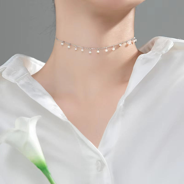 Irma – Pendientes de perlas redondas con borde dorado texturizado.