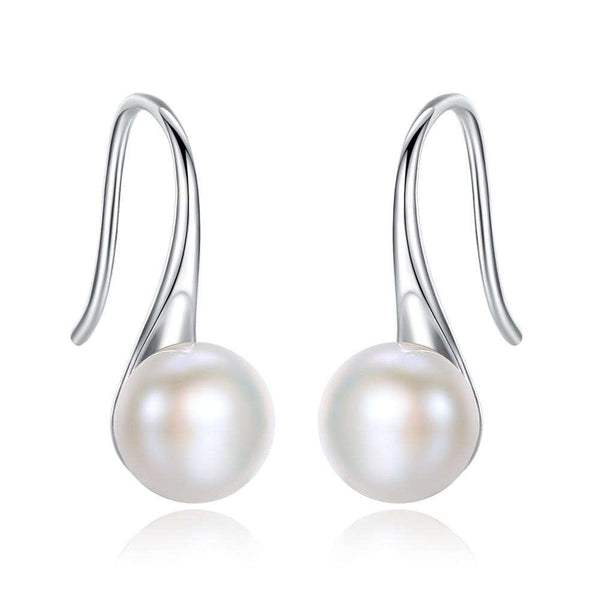 Helena – Pendientes dorados con perla ovalada.
