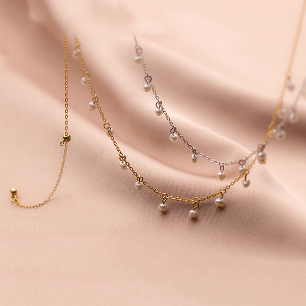 Irma – Pendientes de perlas redondas con borde dorado texturizado.