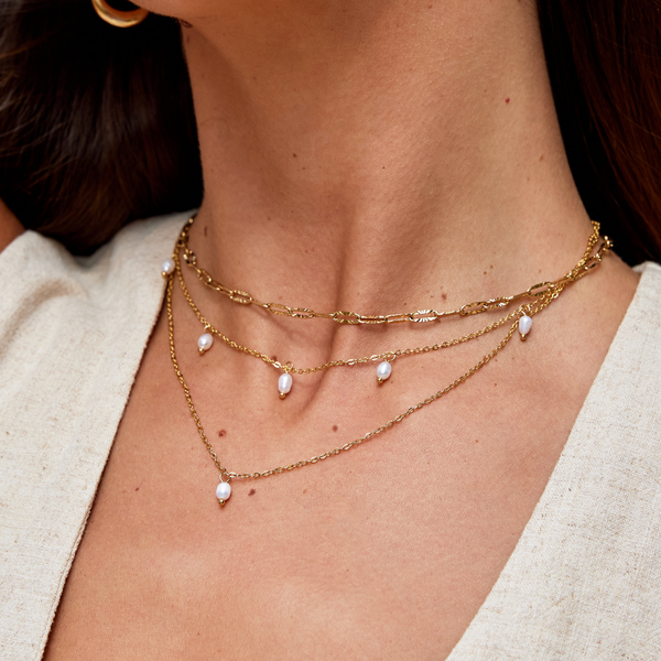 Tanja - Layered gold necklace with modern charm.