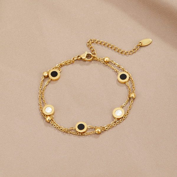 Carla – Pulsera de oro suave con elementos redondos contrastantes.