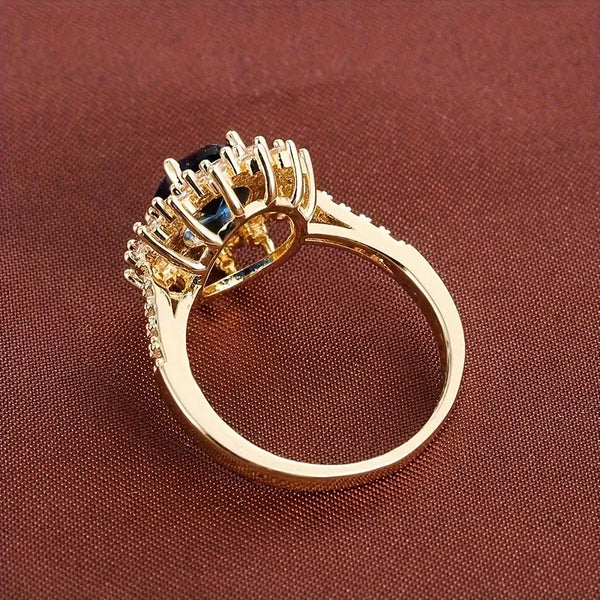 Karolína – Anillo dorado con zafiro floral.