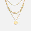 Lea – Collar de múltiples capas en oro suave con líneas elegantes.
