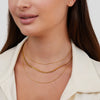 Antonie – Collar dorado de múltiples capas con una estructura clara.