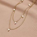 Tanja - Layered gold necklace with modern charm.