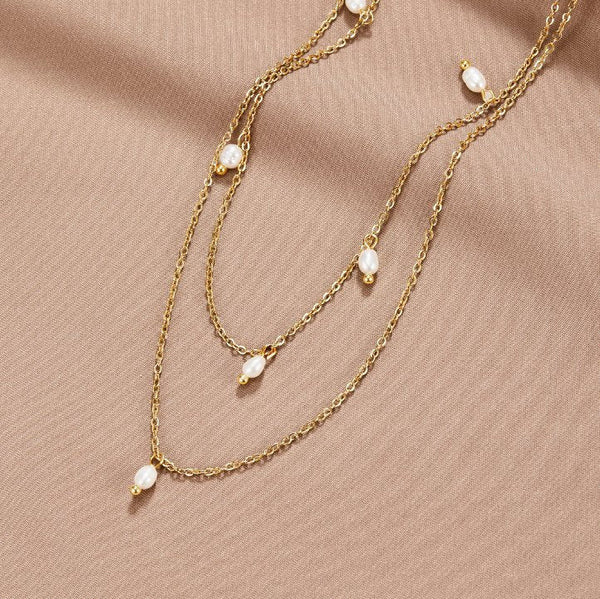 Tanja - Layered gold necklace with modern charm.