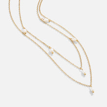 Tanja - Layered gold necklace with modern charm.