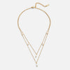 Tanja - Layered gold necklace with modern charm.