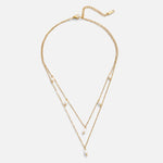 Tanja - Layered gold necklace with modern charm.