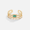 Sabina - Gold ring with emerald green accents.