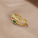 Sabina - Gold ring with emerald green accents.