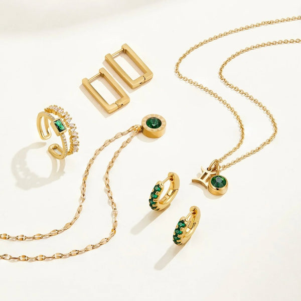 Sabina - Gold ring with emerald green accents.