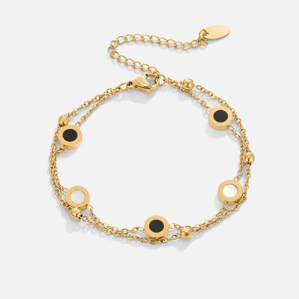 Carla – Pulsera dorada suave con elementos redondos contrastantes.