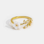 Miriam – Engagement ring with white floral embellishment.
