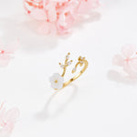 Miriam – Engagement ring with white floral embellishment.